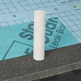 Plumbing pipe on roof surrounded by GAF roof deck underlayment.